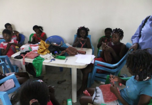 The Moving Sands project group at work making bags out of soda can pop-tops.